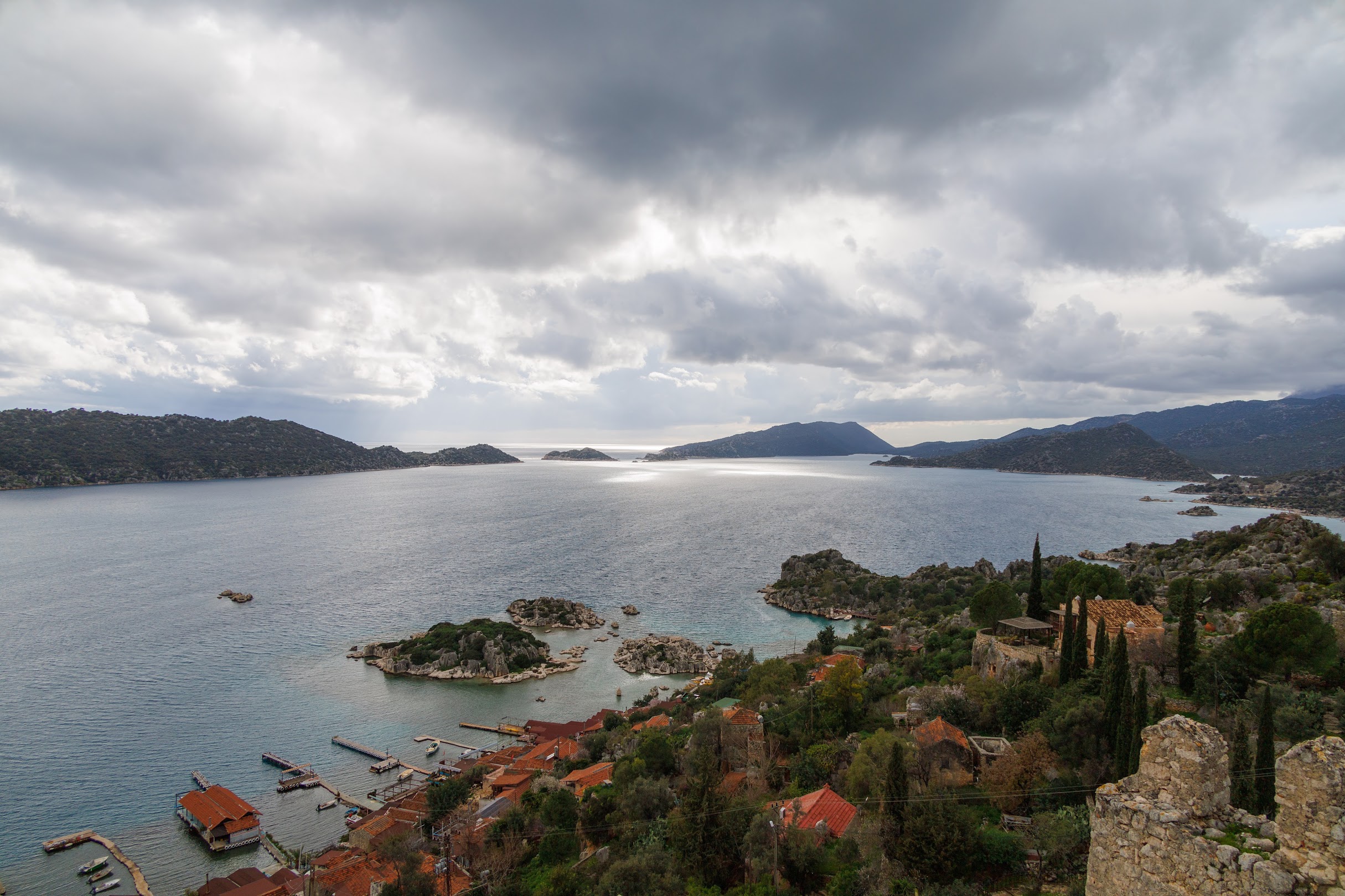 The bay of Kekova and its islands seen from above the village of Simena, with an old stone wall in the foreground